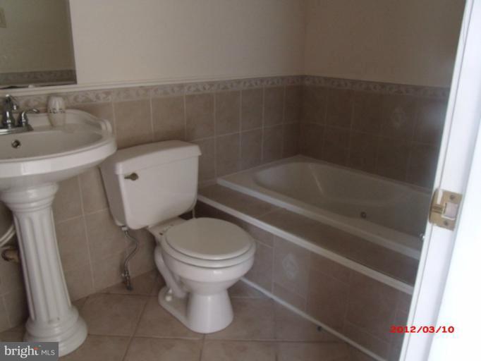 710 Planters Wharf Road Lusby, MD 20657 - Photo 1 of 16 a bathroom with a sink and a toilet