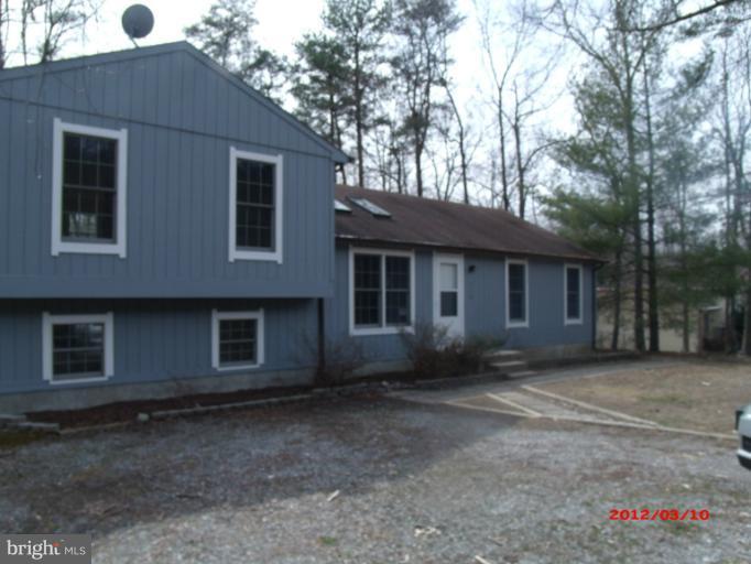 710 Planters Wharf Road Lusby, MD 20657 - Photo 2 of 16 a house with trees in front of it