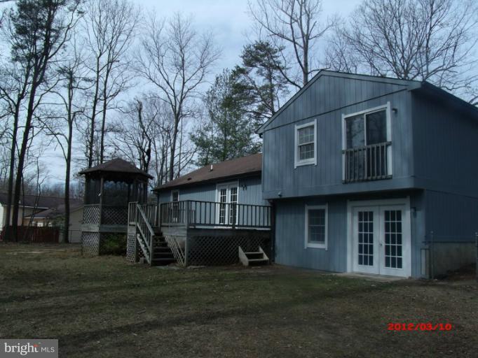 710 Planters Wharf Road Lusby, MD 20657 - Photo 13 of 16 a front view of a house with a yard