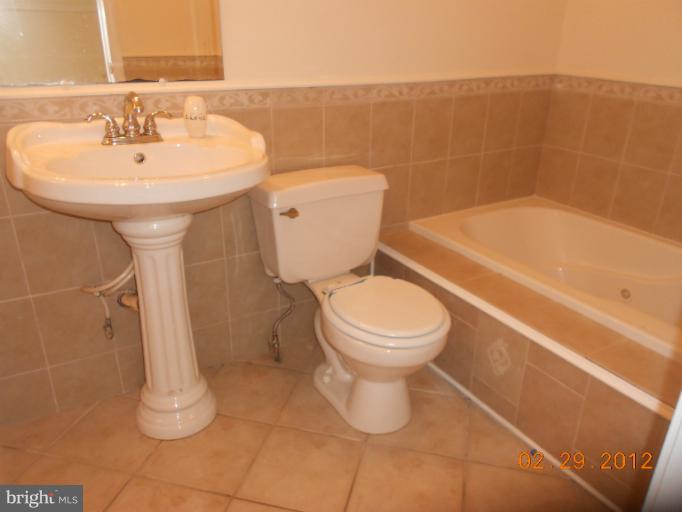 710 Planters Wharf Road Lusby, MD 20657 - Photo 15 of 16 a bathroom with a toilet sink and shower