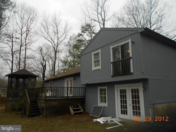 710 Planters Wharf Road Lusby, MD 20657 - Photo 7 of 16 a view of a house with a yard