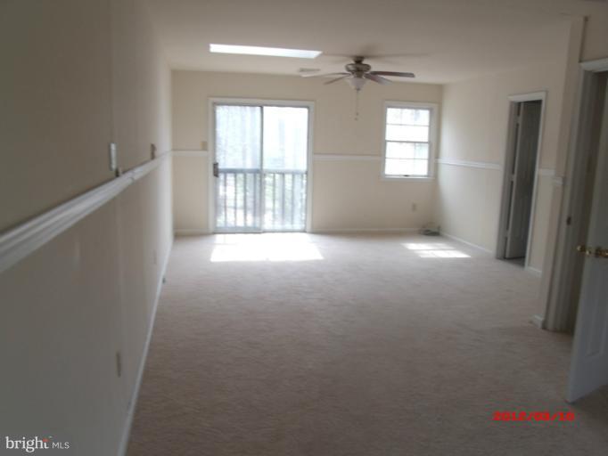 710 Planters Wharf Road Lusby, MD 20657 - Photo 8 of 16 an empty room with windows and stairs