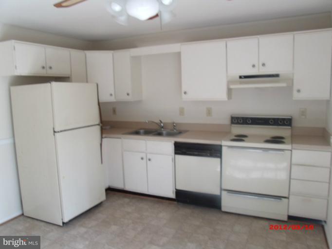 710 Planters Wharf Road Lusby, MD 20657 - Photo 10 of 16 a kitchen with cabinets appliances and a sink