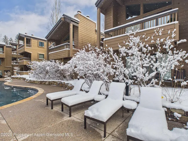 a roof deck with couches and wooden floor