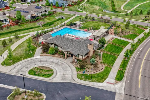 an aerial view of a house with a yard and potted plants