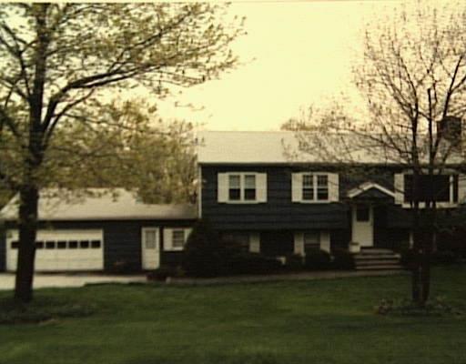 17 Acre Lane Ridgefield, CT 06877 - Photo 1 of 1 a front view of a house with a garden