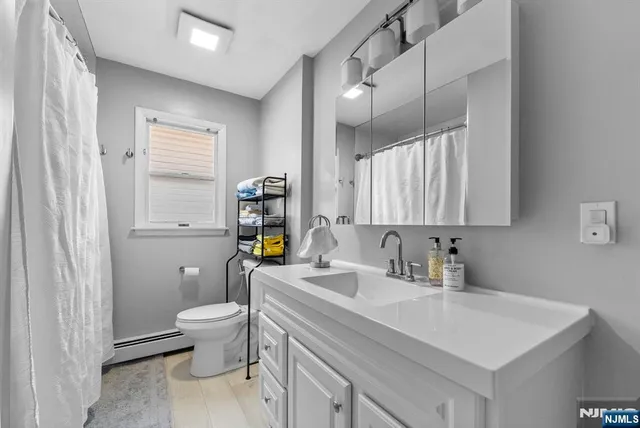 a kitchen with a sink cabinets and wooden floor
