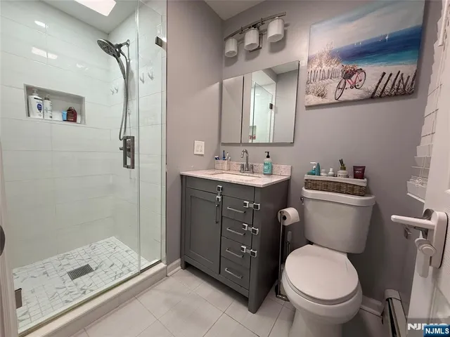 a bathroom with a granite countertop toilet sink and shower