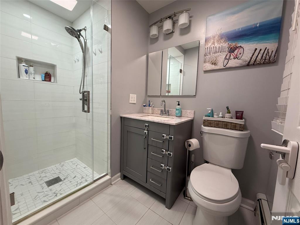 174 Maple Street Fairview, NJ 07022 - Photo 20 of 25 a bathroom with a granite countertop toilet sink and shower