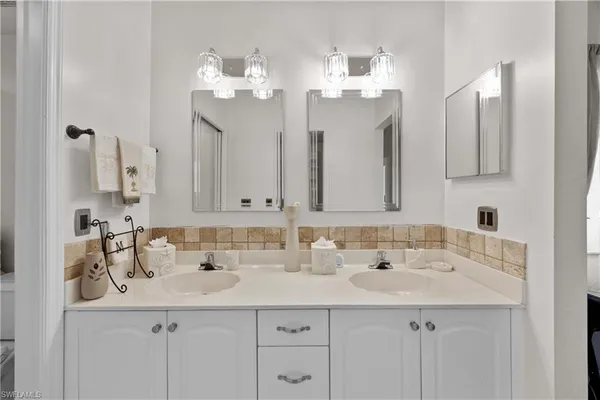 a bathroom with a sink vanity and a mirror