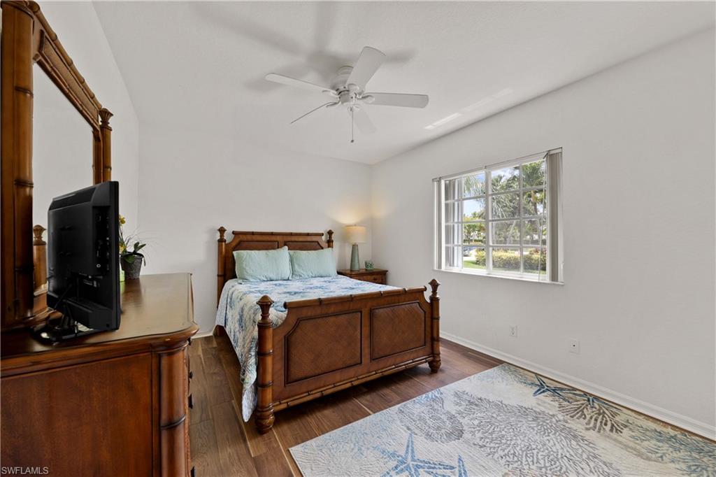 9022 Michael Circle, Unit 1 Naples, FL 34113 - Photo 18 of 29 a bed room with a bed window and a flat screen tv