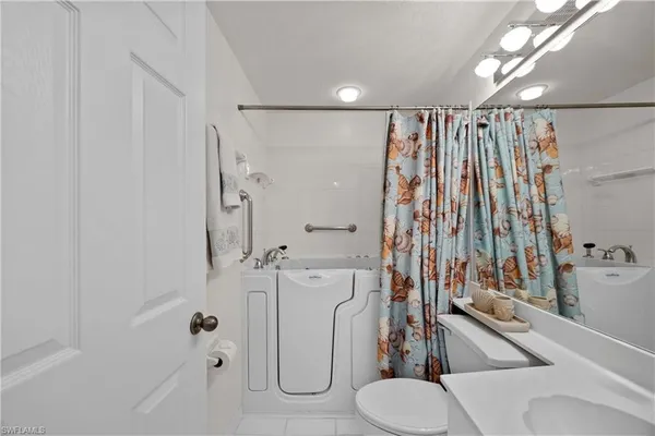 a bathroom with a shower and a toilet