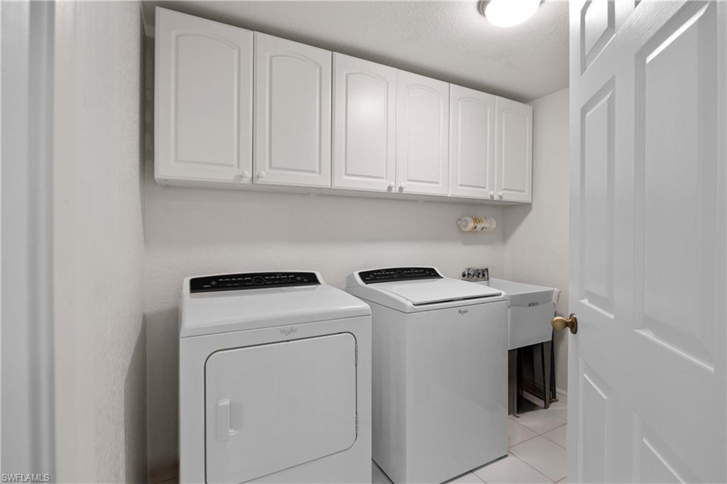 9022 Michael Circle, Unit 1 Naples, FL 34113 - Photo 21 of 29 a utility room with dryer and washer