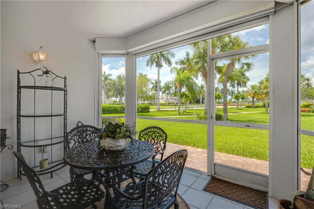 9022 Michael Circle, Unit 1 Naples, FL 34113 - Photo 23 of 29 a view of a room with a furniture and floor to ceiling window