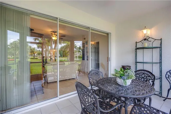 a room with dining table and a glass door
