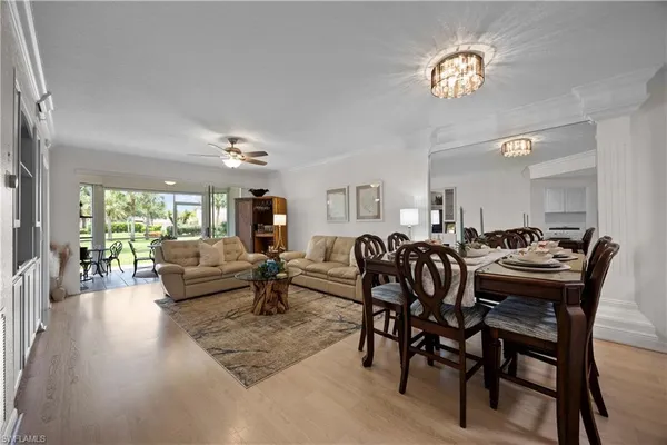 a dining room with furniture a rug a fireplace and wooden floor