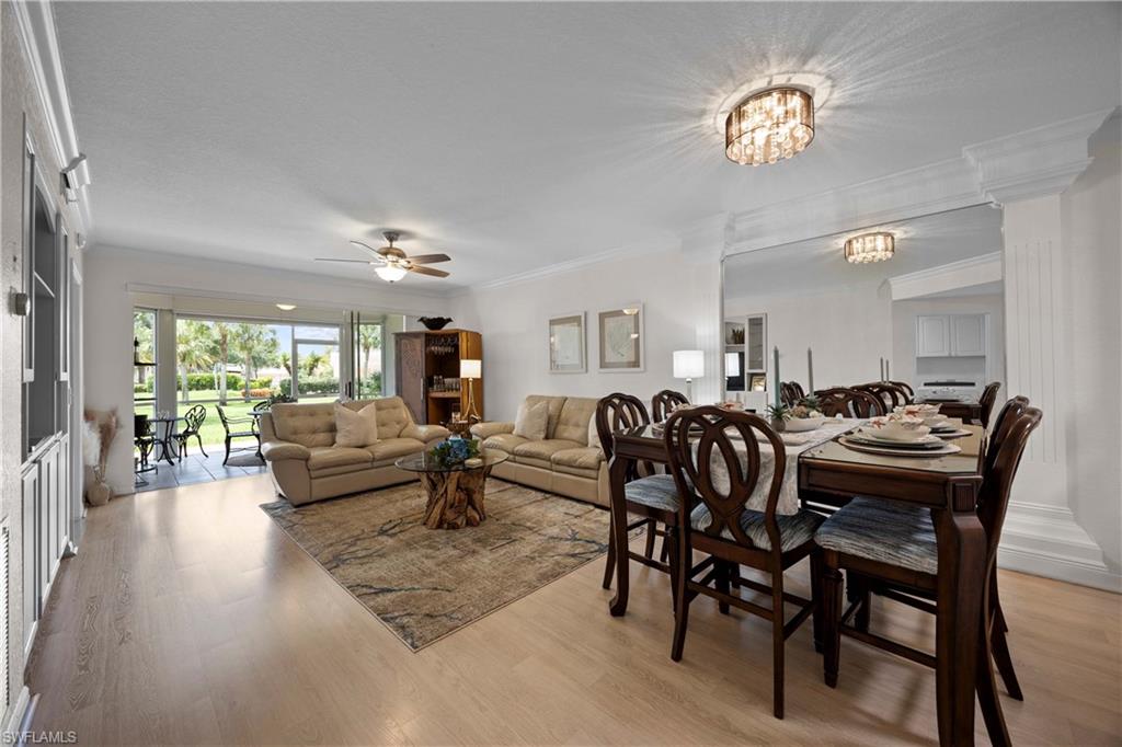 9022 Michael Circle, Unit 1 Naples, FL 34113 - Photo 5 of 29 a dining room with furniture a rug a fireplace and wooden floor