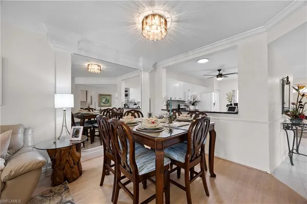 a view of a dining room with furniture and a chandelier