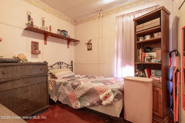 a bedroom with a bed and a book shelf