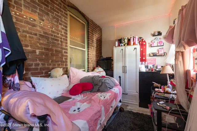 a bedroom with bed and a fireplace