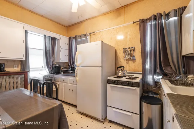 a kitchen with a refrigerator and a stove top oven