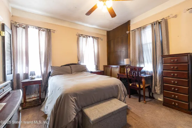 a bedroom with a bed and a dresser