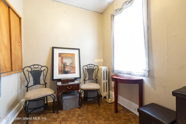 a living room with furniture a window and a potted plant