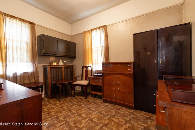 a view of a workspace with furniture and a flat screen tv