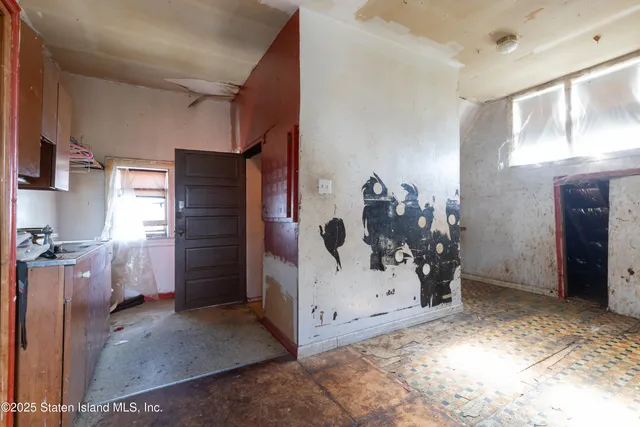 a view of a livingroom with furniture and stairs