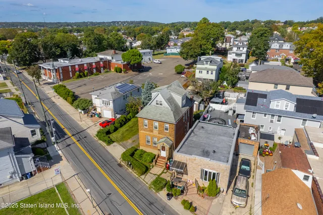 an aerial view of a house with a yard