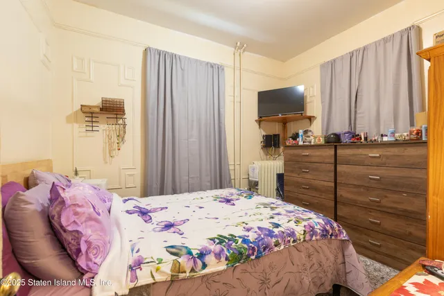 a bedroom with a bed and a mirror