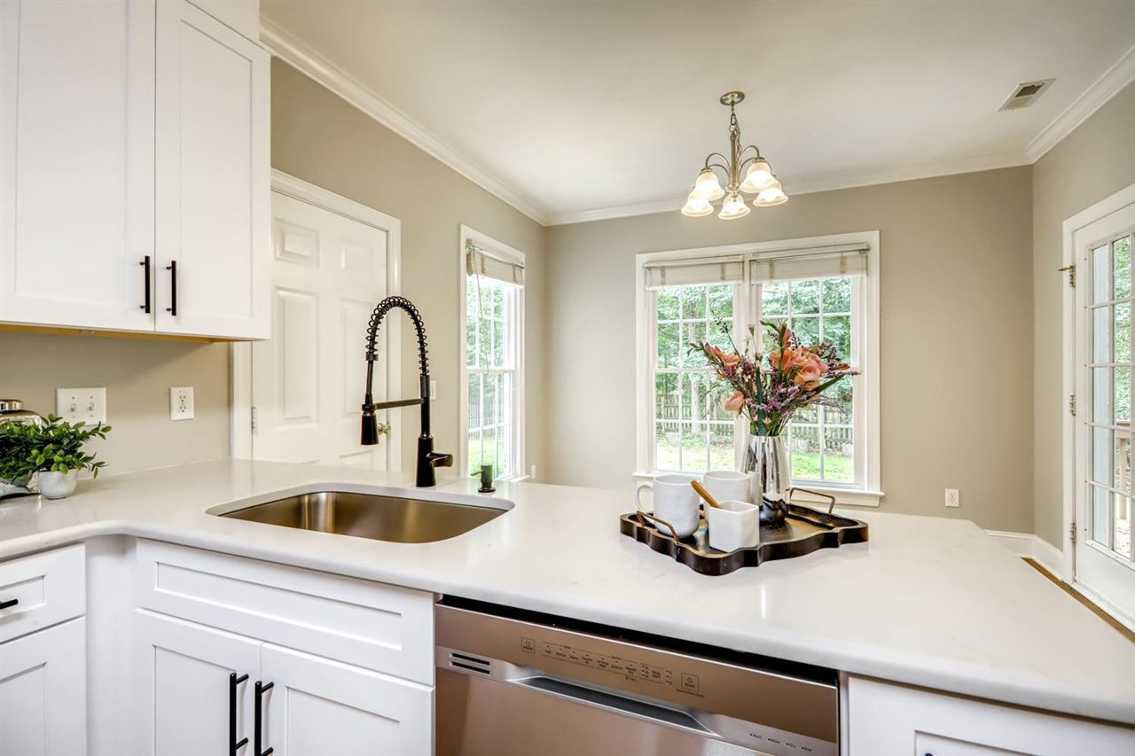 5205 Covington Bend Drive Raleigh, NC 27613 - Photo 2 of 16 Another view of the kitchen, tons of counter & cabinet space! Don't miss the large cabinet that's accessed from the back side of the cabinets by the back door. Kitchen