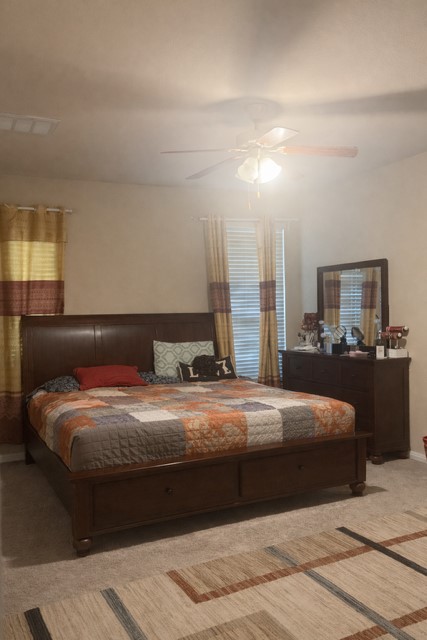 11613 Reading Court Austin, TX 78717 - Photo 8 of 16 a bedroom with a bed and a night stand