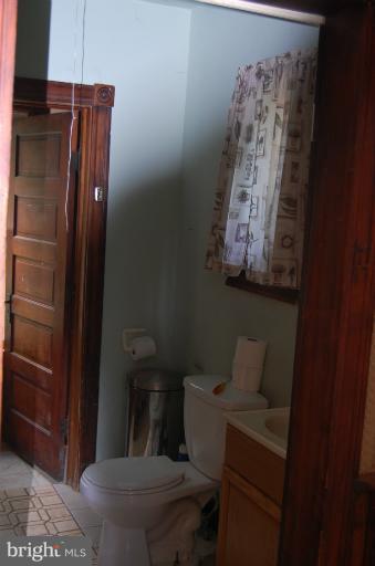 13508 Motters Station Road Rocky Ridge, MD 21778 - Photo 2 of 19 a bathroom with a toilet and a shower curtain