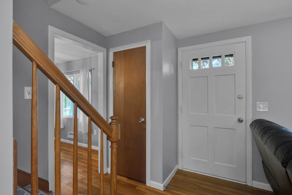 97 Hadley Street Springfield, MA 01118 - Photo 14 of 37 a view of a hallway with wooden floor and stairs