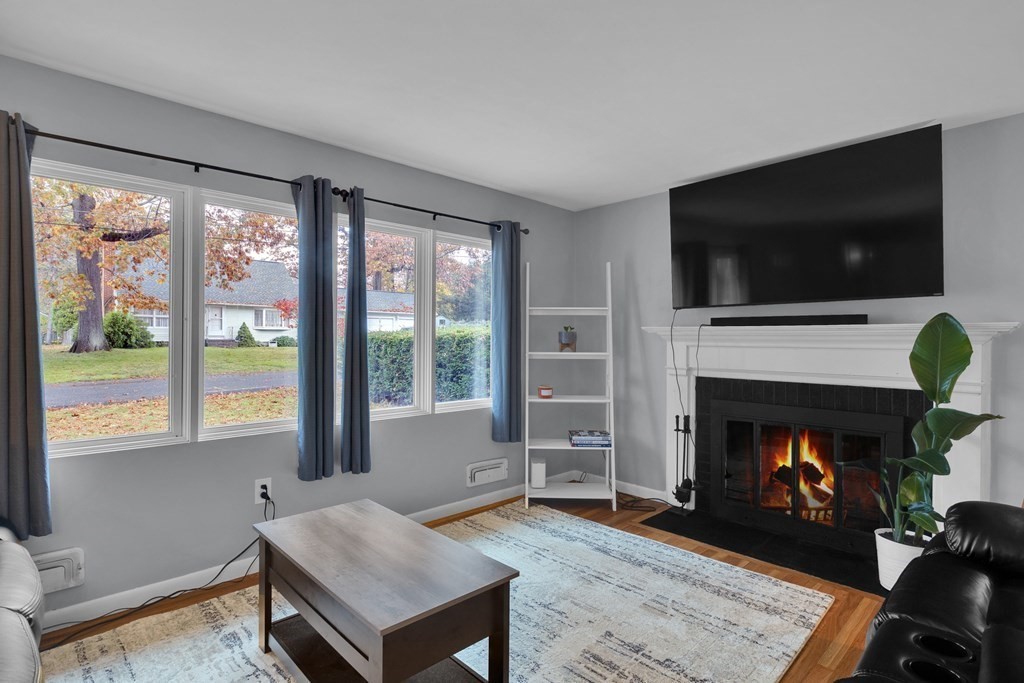 97 Hadley Street Springfield, MA 01118 - Photo 16 of 37 a living room with furniture a flat screen tv and a fireplace