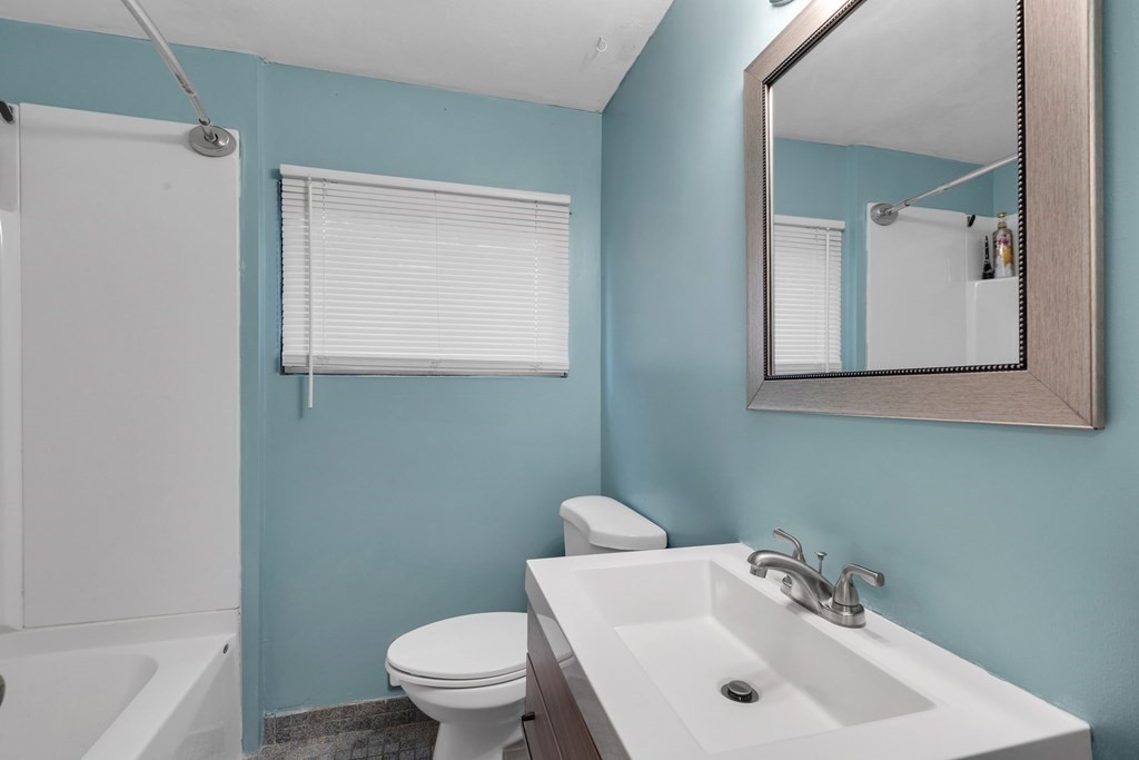 97 Hadley Street Springfield, MA 01118 - Photo 19 of 37 a bathroom with a sink a toilet and a mirror
