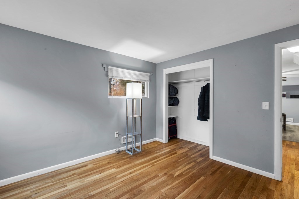 97 Hadley Street Springfield, MA 01118 - Photo 21 of 37 a view of a bedroom with wooden floor and window