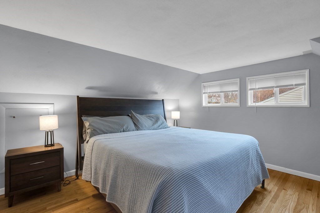 97 Hadley Street Springfield, MA 01118 - Photo 25 of 37 a bedroom with a bed and wooden floor