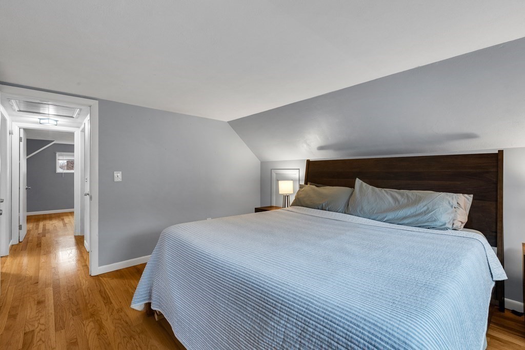 97 Hadley Street Springfield, MA 01118 - Photo 26 of 37 a bedroom with a bed and wooden floor