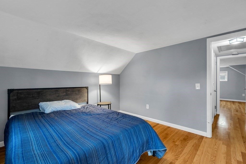 97 Hadley Street Springfield, MA 01118 - Photo 31 of 37 a bedroom with a bed and wooden floor