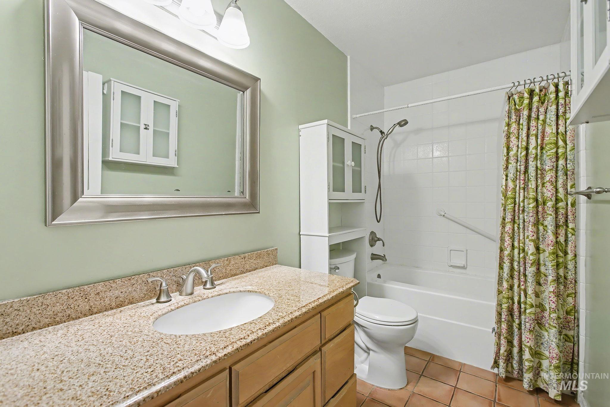 2242 Chukar Lane Clarkston, WA 99403 - Photo 17 of 41 Bathroom with vanity, shower / bathtub combination with curtain, and light tile patterned flooring