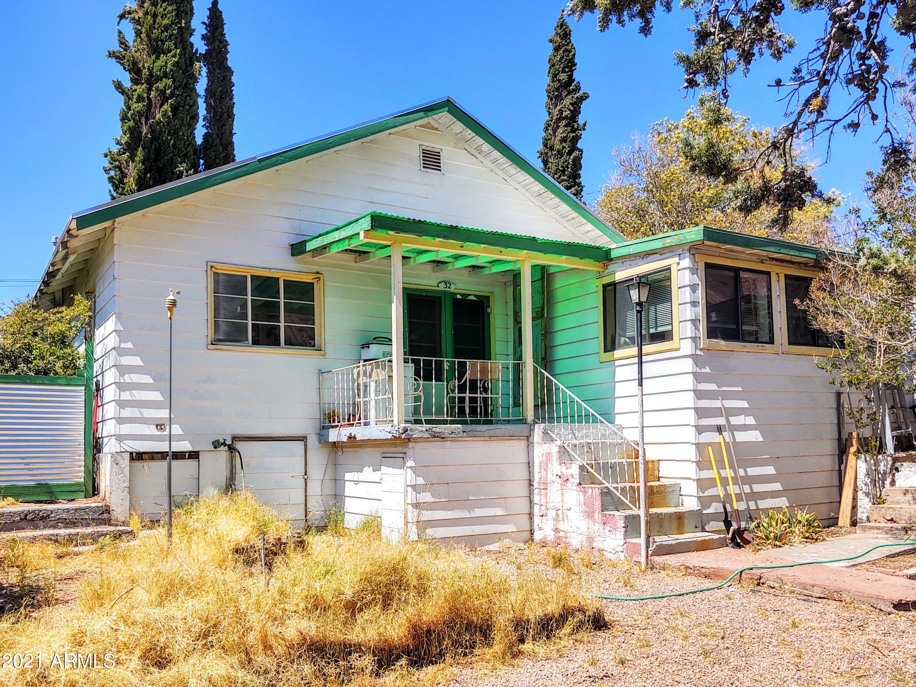 a front view of a house with a yard outdoor seating and garage