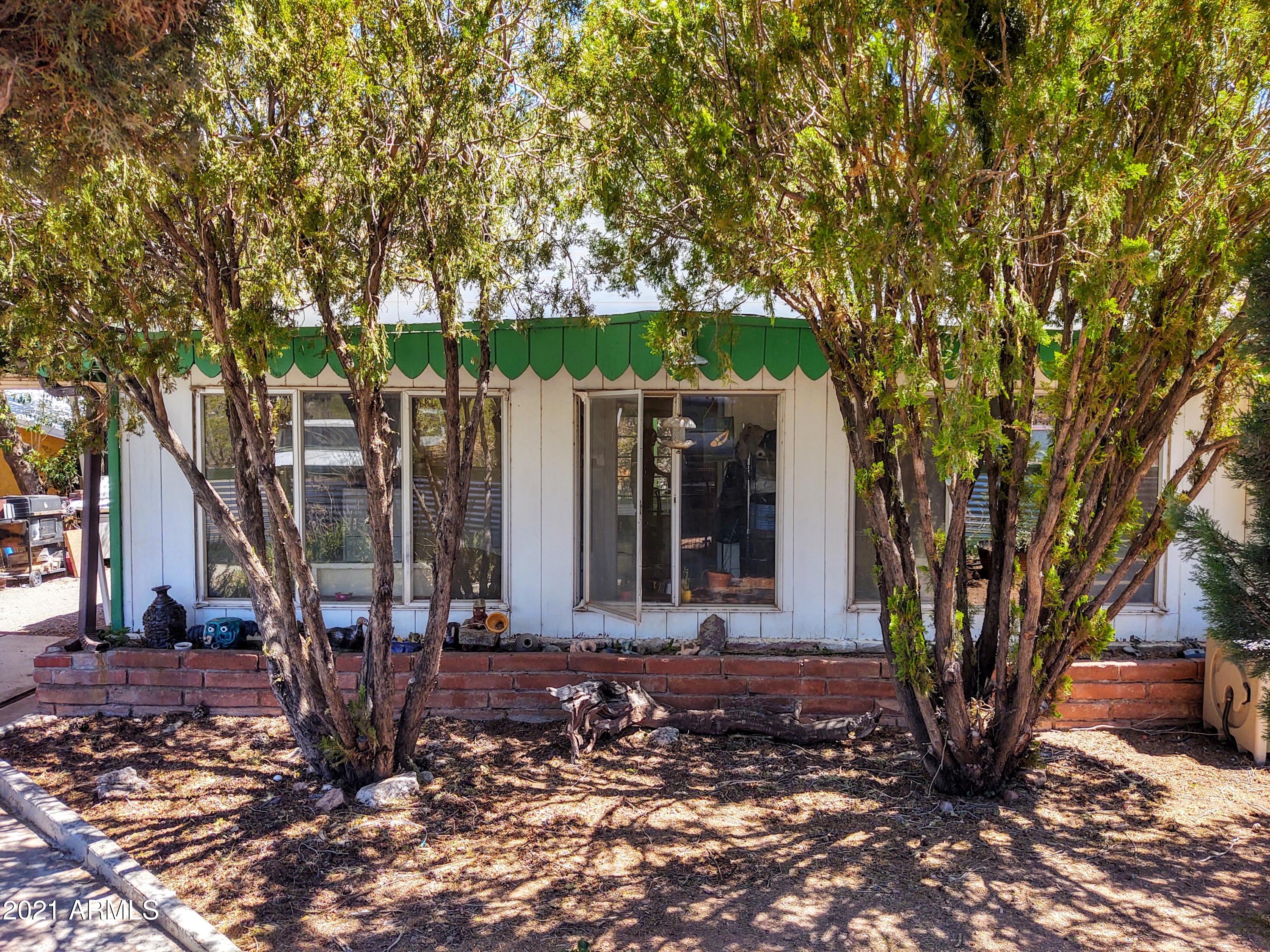 32 Old Douglas Road Bisbee, AZ 85603 - Photo 2 of 16 a view of a house with backyard and trees