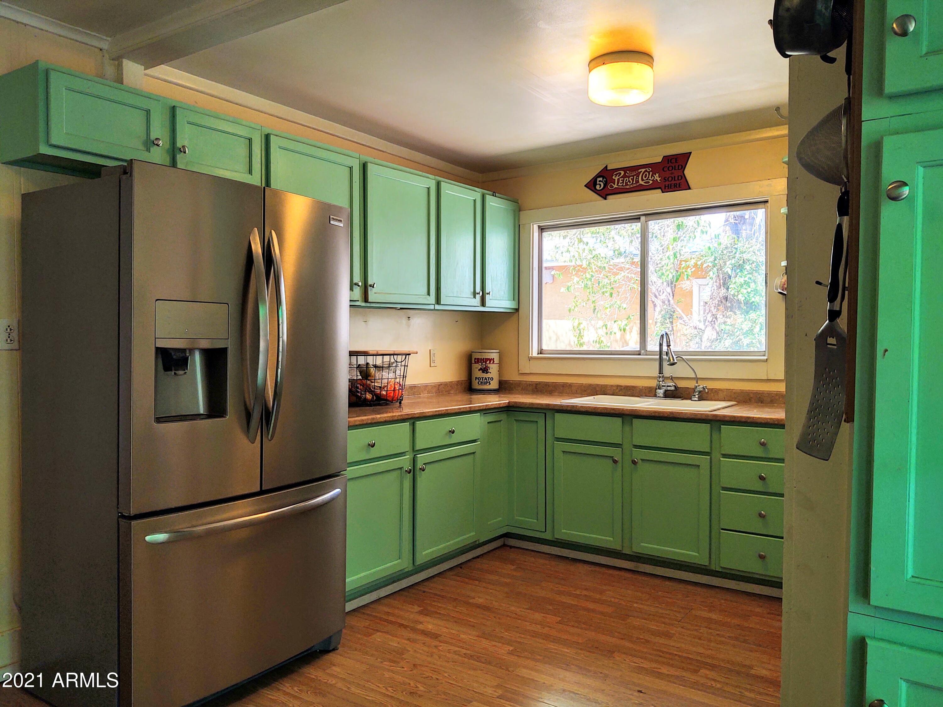 32 Old Douglas Road Bisbee, AZ 85603 - Photo 5 of 16 a kitchen with a refrigerator and a sink
