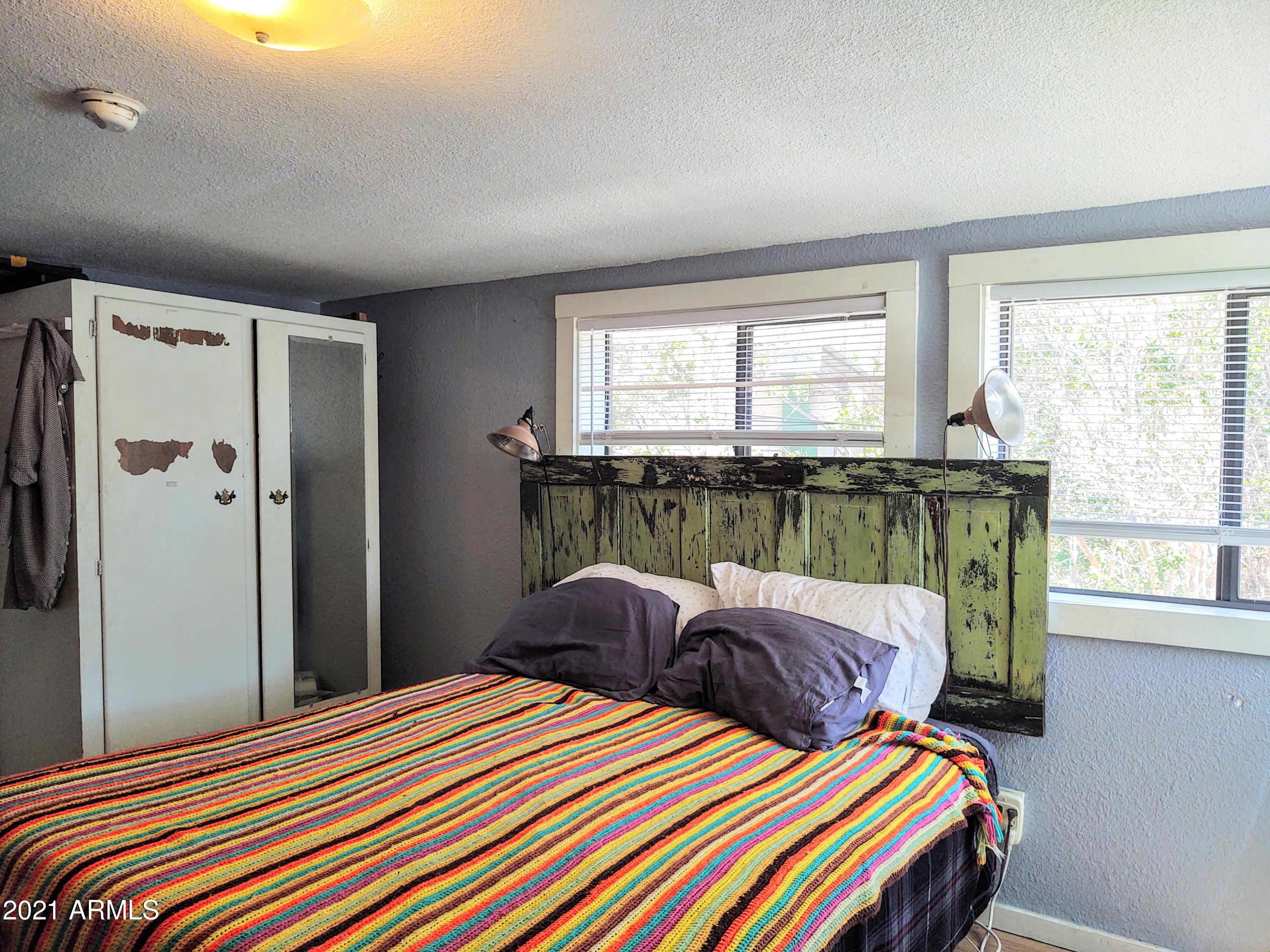 32 Old Douglas Road Bisbee, AZ 85603 - Photo 8 of 16 a bedroom with a bed and a window