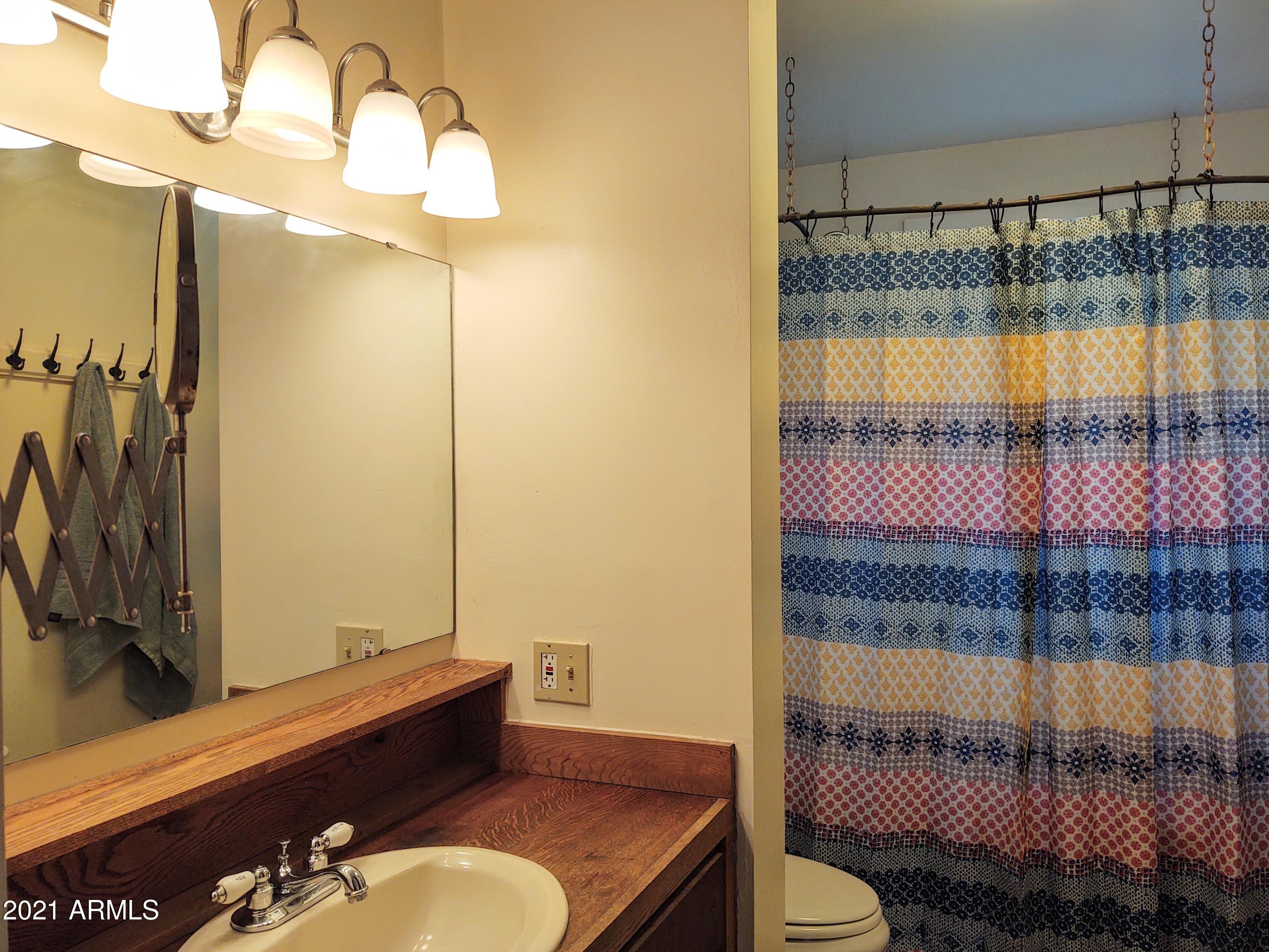 32 Old Douglas Road Bisbee, AZ 85603 - Photo 10 of 16 a bathroom with a sink toilet and shower