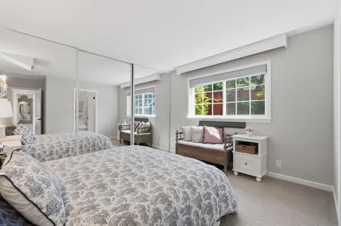 a bedroom with a bed and a couch