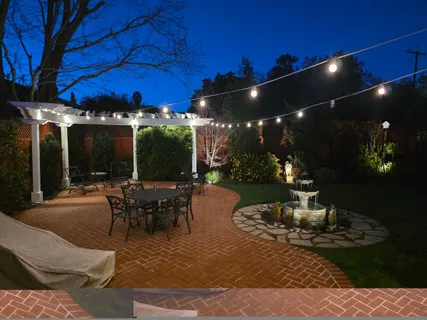 a view of a backyard with sitting area
