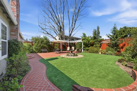 a view of a house with swimming pool and a yard